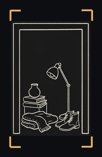A doorway with a pile of household things: a lamp, a vase, books, a blanket, boots