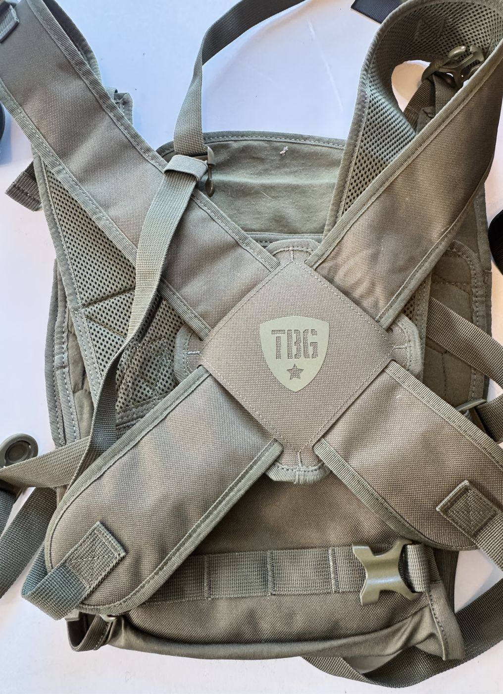 Tactical Baby Gear carrier in ranger green, back panel with shield logo